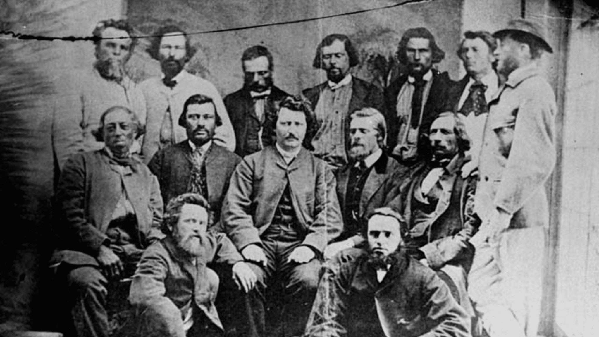 Black and white photograph of Louis Riel surrounded by other people