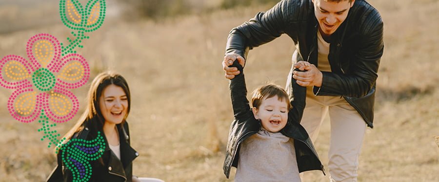 Young family enjoying a fall evening outdoors next to a Metis style bead work design
