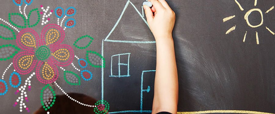 Child's hand drawing a house on a chalkboard with Metis style beadwork motif overlay
