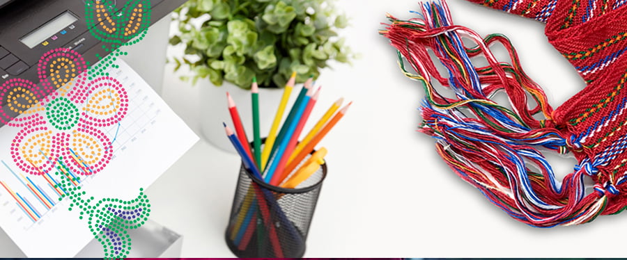 Red Metis sash on a table with a beadwork motif and office supplies